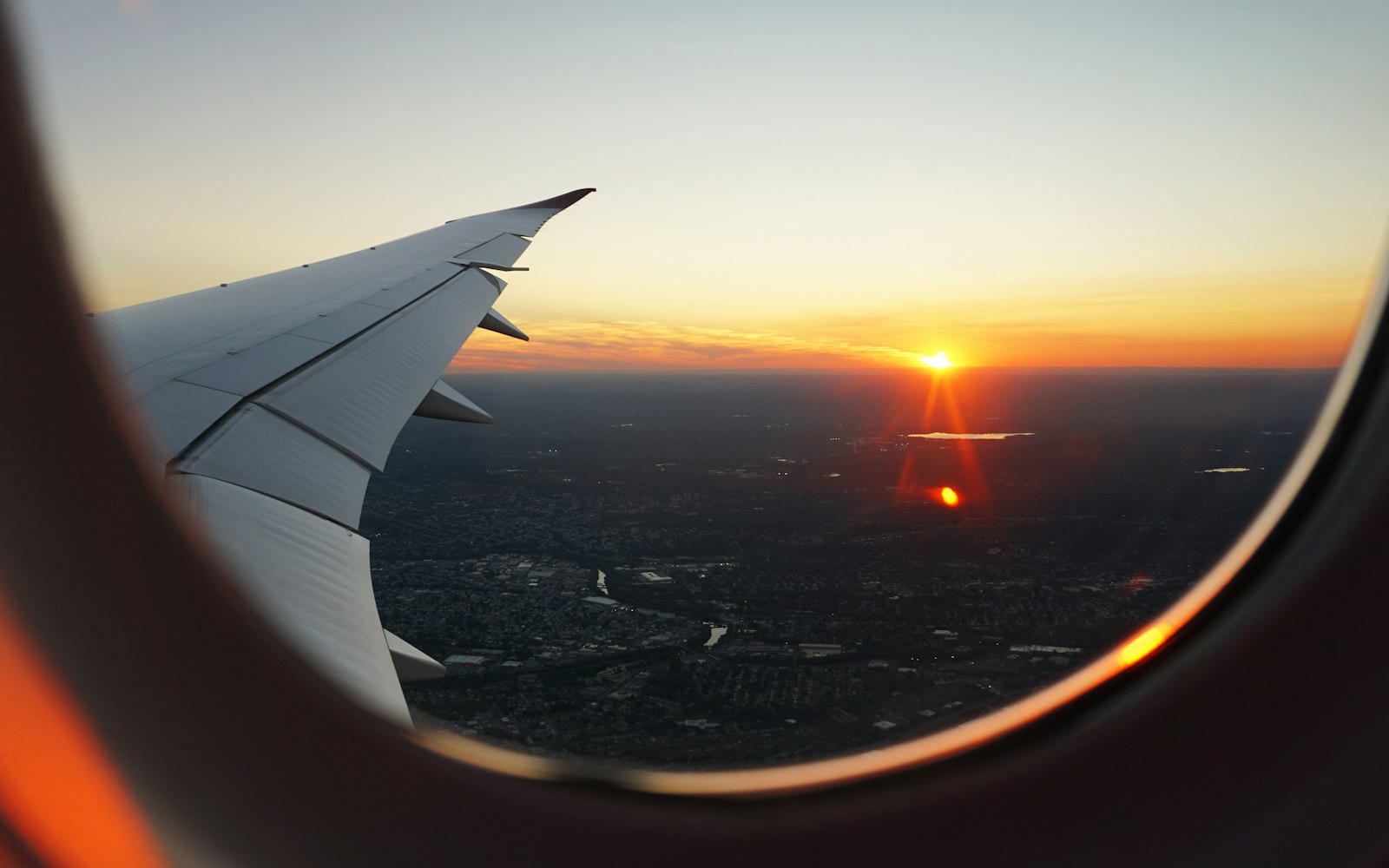 View from an airplane window at sunset